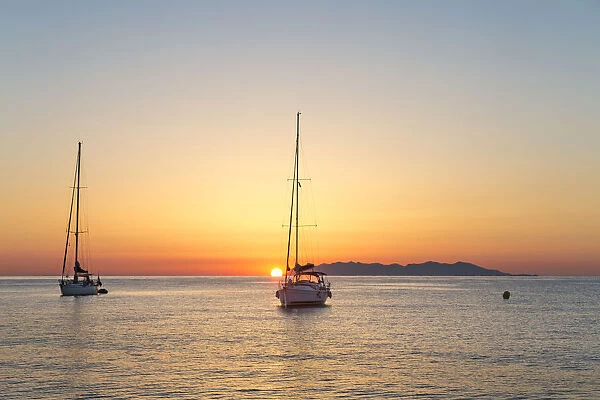Sailing boats at sunrise, on background Capraia Island (Macinaggio, Rogliano, Bastia