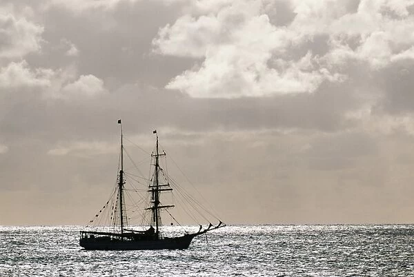 A sailing ship anchored in front of Hanga Roa