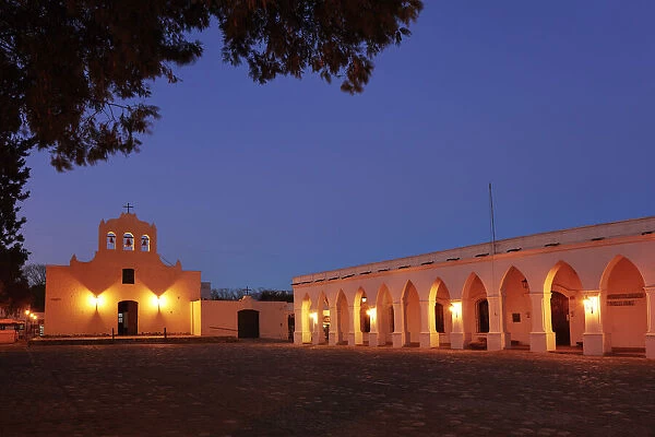 The 'San Jose Church' and the arches of the Archaeological Museum Pio Pablo Diaz illuminated at night, Cachi, Salta province, Argentina