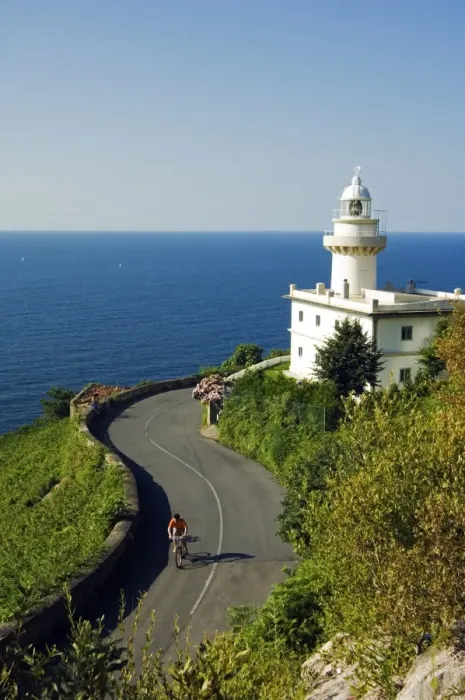 Framed Print : San Sebastian Bay Clifftop Lighthouse with Cyclist Riding uphill Framed Print : San Sebastian Bay Clifftop Lighthouse with Cyclist Riding uphill
