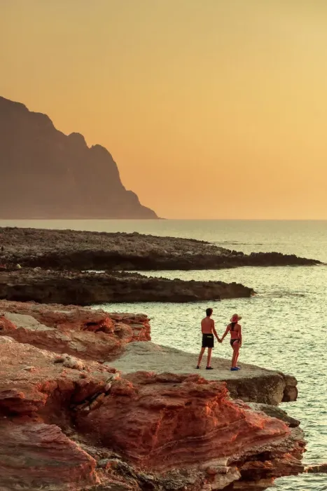 Framed Print : San Vito lo Capo, Sicily. A couple enjoying the sunset on the rock formations along Framed Print : San Vito lo Capo, Sicily. A couple enjoying the sunset on the rock formations along