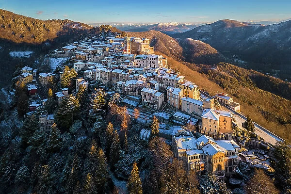 Santa Maria del Monte after a snowfall in winter at sunrise. Varese, Parco Campo dei Fiori, Lombardy, Italy