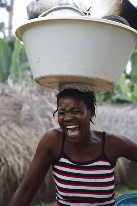 Framed Print : A Sao Tomense woman laughs while carrying her washing up on her head Framed Print : A Sao Tomense woman laughs while carrying her washing up on her head