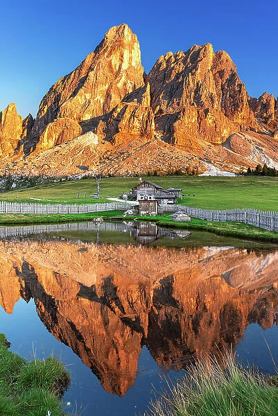 Sass de Putia reflection in the water of a small lake at sunset, Passo delle Erbe, Dolomites, Puez Odle, Bolzano district, South Tyrol, Italy