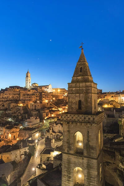 The Sassi quarter at dusk, with San Pietro Barisano bell tower in the foreground. Matera