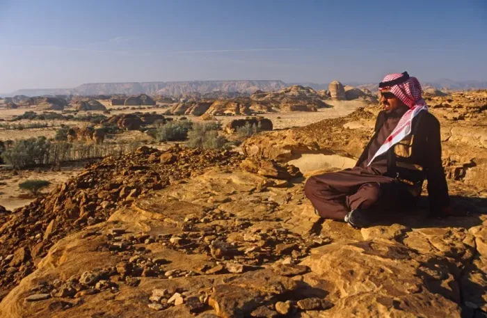 Framed Print : Saudi Arabia, Madinah, nr. Al-Ula, Madain Saleh (aka Hegra). A Saudi man gazes at stark cliffs Framed Print : Saudi Arabia, Madinah, nr. Al-Ula, Madain Saleh (aka Hegra). A Saudi man gazes at stark cliffs