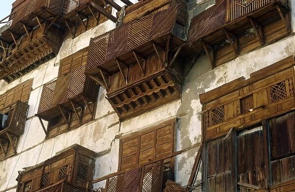 Saudi Arabia, Makkah, Jeddah. Al-Balad, the historic heart of Jeddah, still contains some 19th-century buildings with their distinctive mashrabiyas (Arab oriel windows) - wooden latticework screening windows and supporting small