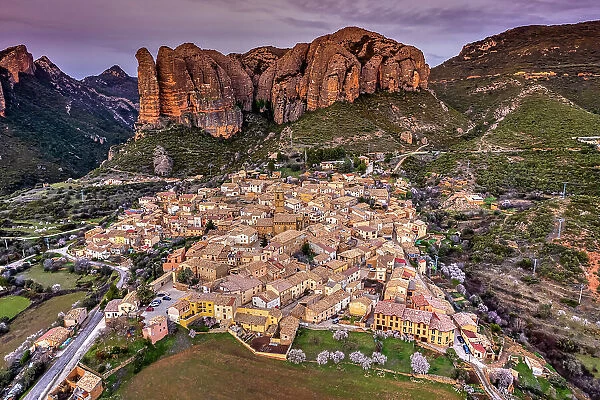 Scenic aerial view of the village with the Mallos de Aguero rock formations behind, Aguero, Huesca, Aragon, Spain