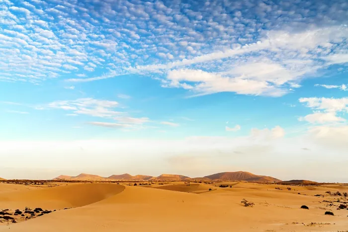 Framed Print : Scenic clouds at dawn over the golden sand dunes of Corralejo Natural Park, Fuerteventura, Canary Islands, Spain