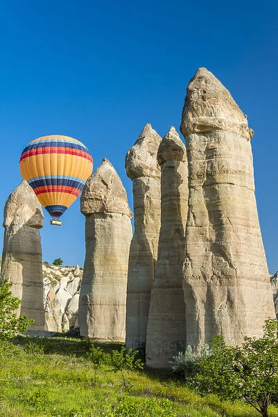Scenic fairy chimneys landscape with hot air balloon, Goreme, Cappadocia, Turkey