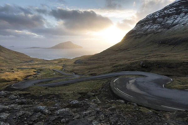 The scenic road for Norðradalur at sunset. The island of Koltur in the background. Faroe Islands