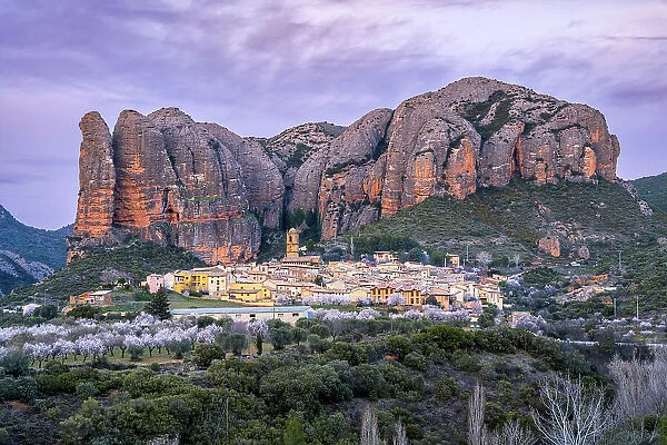 Scenic view of the village with the Mallos de Aguero rock formations behind, Aguero, Huesca, Aragon, Spain