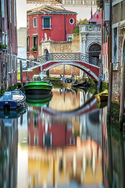 Scenic water canal with bridge reflected, Venice, Veneto, Italy