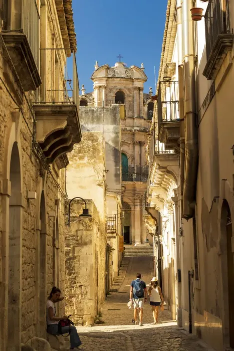 Framed Print : Scicli, Sicily. People walking in the narrow streets with San Giovanni Evangelista Framed Print : Scicli, Sicily. People walking in the narrow streets with San Giovanni Evangelista