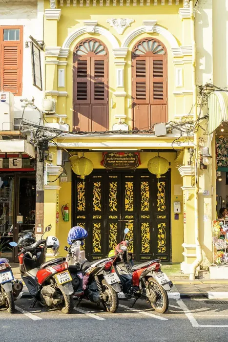 Framed Print : Scooter riding past beautiful buildings in the Old town, Phuket, Thailand Framed Print : Scooter riding past beautiful buildings in the Old town, Phuket, Thailand