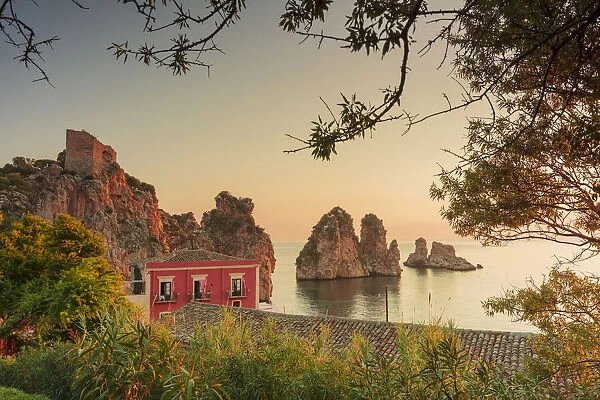Scopello, Sicily. Elevated view of the tonnara and the sea stacks at sunrise