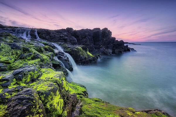 The Sea Waterfall at Dunseverick on the Antrim Coast, north coast of Ireland, County Antrim, Northern Ireland, Uk, Europe