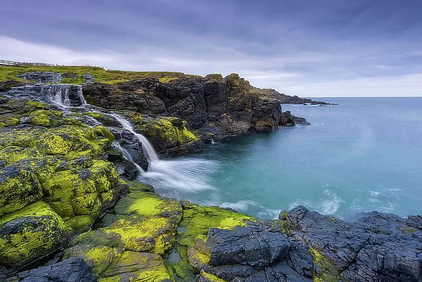 The Sea Waterfall at Dunseverick on the Antrim Coast, north coast of Ireland, County Antrim, Northern Ireland, Uk, Europe