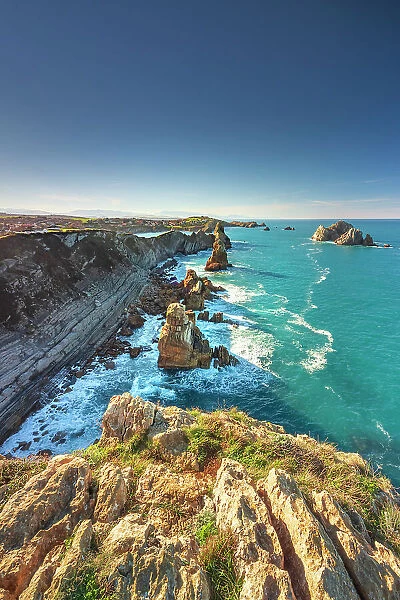 Seascape of Los Urros in the cantabrian sea of Costa Quebrada at sunset. Playa del Portio, Liencres, Cantabria, Spain