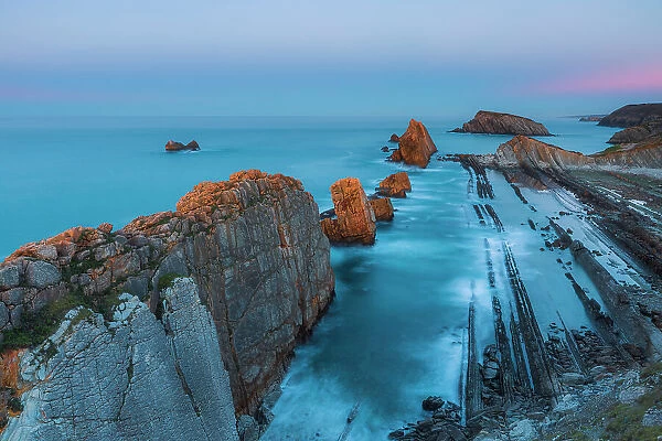 Seascape of Los Urros in the cantabrian sea of Costa Quebrada at sunset. Playa del Portio, Liencres, Cantabria, Spain