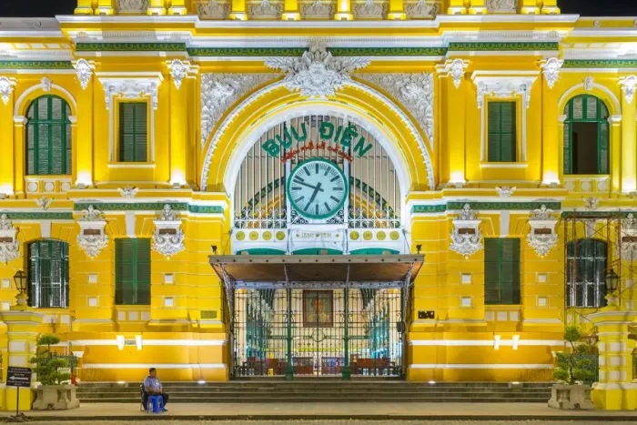 Framed Print : A security guard sits outside of Saigon Central Post Office at night, Ho Chi Minh City