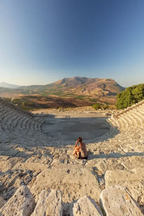 Framed Print : Segesta, Sicily. A woman sitting alone in the greek theater of Segesta at sunset Framed Print : Segesta, Sicily. A woman sitting alone in the greek theater of Segesta at sunset