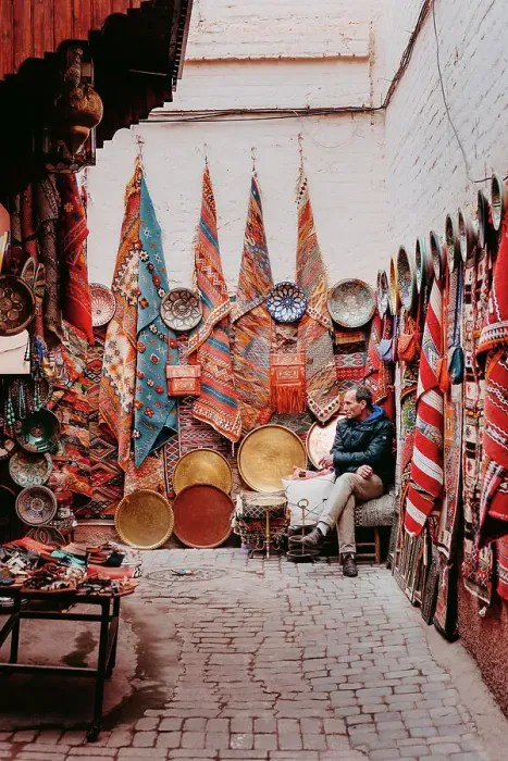Framed Print : Seller of carpets and fabrics in the souk, Marrakech Framed Print : Seller of carpets and fabrics in the souk, Marrakech