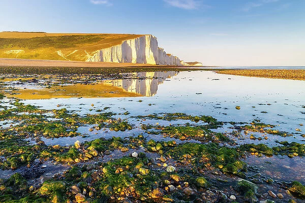 Seven Sisters reflected on Cuckmere Haven beach at sunset, Sussex, England, United Kingdom