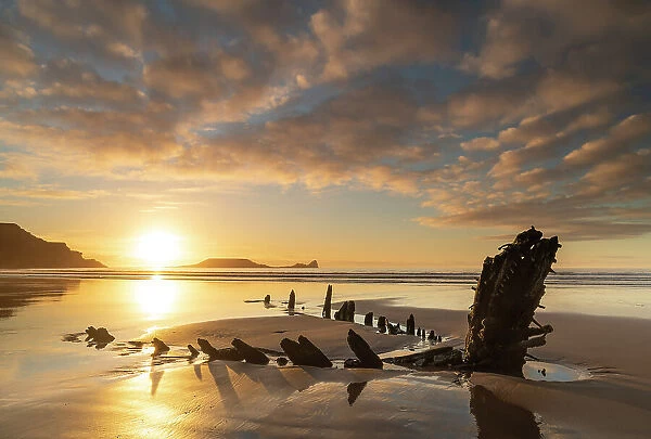 Shipwreck of the Helvetia on the sandy shores of Rhossili Bay at sunset, Gower Peninsula, South Wales, UK. Winter (January) 2020