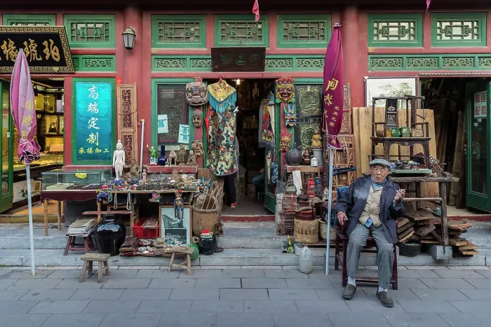 Framed Print : Shopkeeper outside antique shop, Beijing, China Framed Print : Shopkeeper outside antique shop, Beijing, China