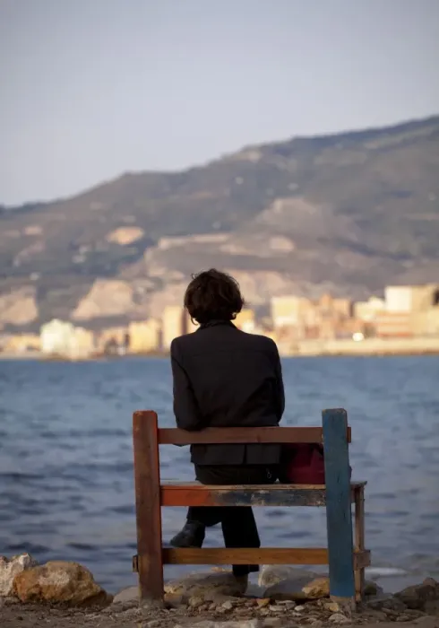 Framed Print : Sicily, Italy, Western Europe; A person sitting on a bench facing the fishing port of Trapani Framed Print : Sicily, Italy, Western Europe; A person sitting on a bench facing the fishing port of Trapani