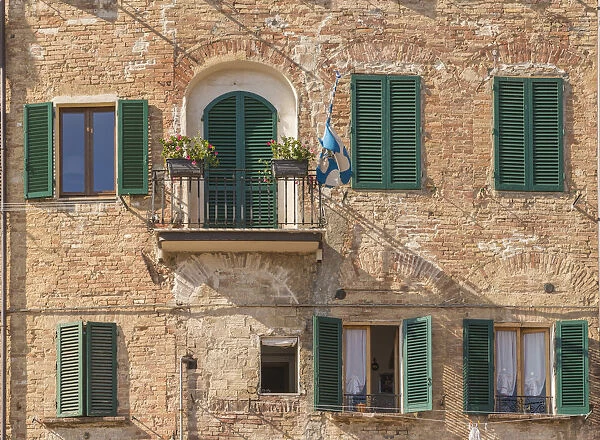 Siena, Tuscany, Italy, Europe. A contrada flag on a balcony