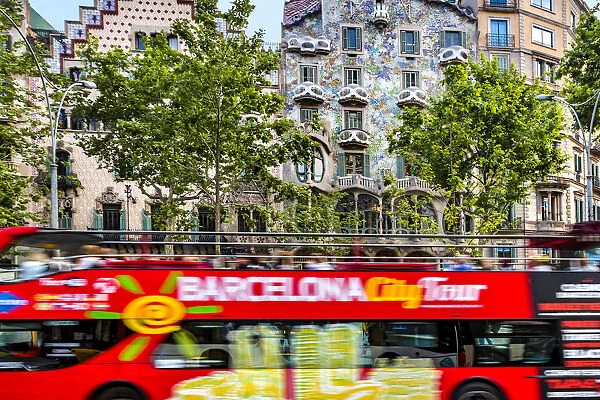 Sightseeing bus in front of Casa Batllo, Barcelona, Catalonia, Spain