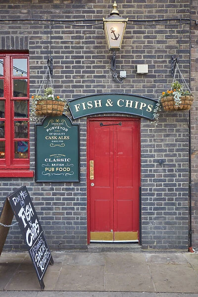 A signboard saying 'Fish & Chips'over the door of the 'Anchor Bankside'traditional pub, Bankside, London, United Kingdom
