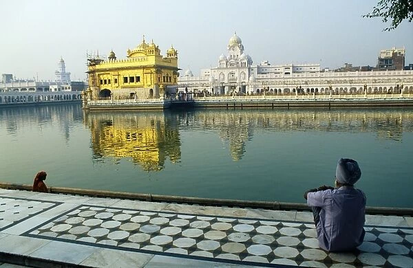 A Sikh pilgrim pauses for reflection by Amrit Sarovar