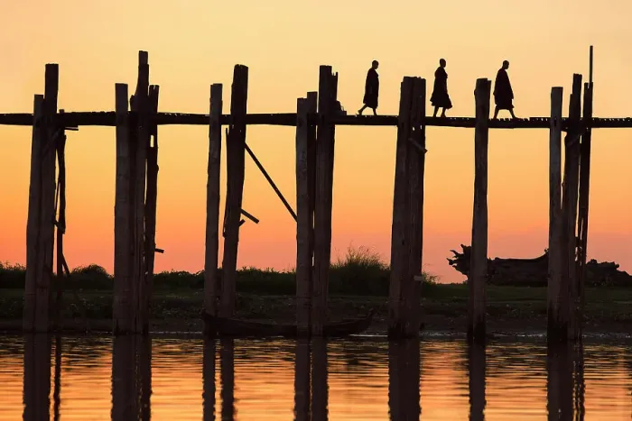 Framed Print : Silhouette of three Buddhists monks walking on the U-Bein wooden teak bridge at sunset, Taungthaman Lake, Amarapura, Mandalay, Myanmar Framed Print : Silhouette of three Buddhists monks walking on the U-Bein wooden teak bridge at sunset, Taungthaman Lake, Amarapura, Mandalay, Myanmar
