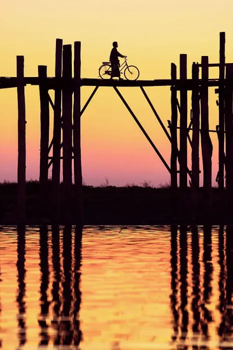 Framed Print : Silhouette of a person with a bicycle walking on the U-Bein wooden teak bridge at sunset, Taungthaman Lake, Amarapura, Mandalay, Myanmar Framed Print : Silhouette of a person with a bicycle walking on the U-Bein wooden teak bridge at sunset, Taungthaman Lake, Amarapura, Mandalay, Myanmar