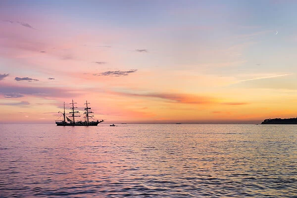 Silhouette of sailing ship at sunset off the coast of Cassis, Bouches-du-RhA'ne