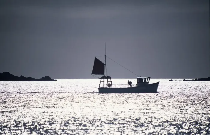 Framed Print : A silhouetted fishing boat passes the Eastern Isles Framed Print : A silhouetted fishing boat passes the Eastern Isles