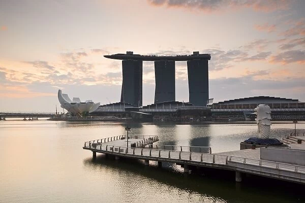 Singapore, Singapore, Marina Bay. The Merlion Statue at dawn, with the Marina Bay Sands in the background