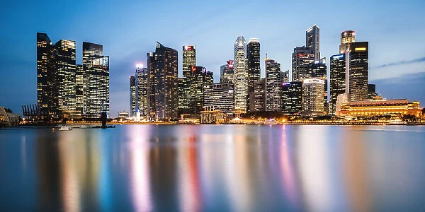 Singapore skyline at night reflected in lake, Singapore
