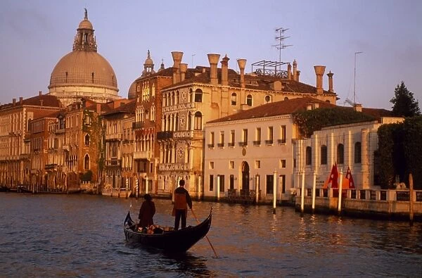 A single gondola on the Grand Canal at sunset with