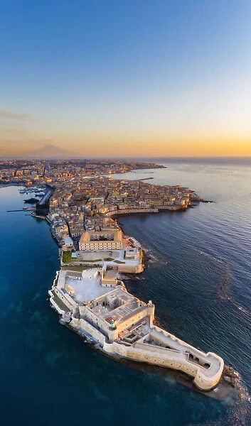 Siracusa, Sicily. Aerial view of Ortigia island at sunrise with Etna mountain in the