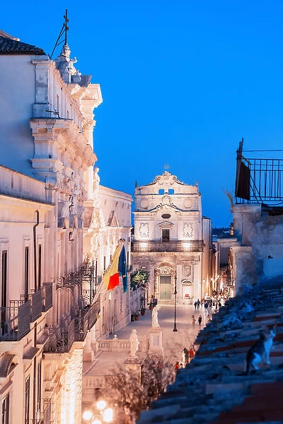 Siracusa, Sicily. People visiting Duomo square with the Cathedral at dusk