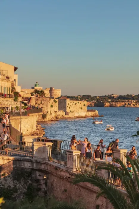 Framed Print : Siracusa, Sicily. People walking by the sea at sunset
