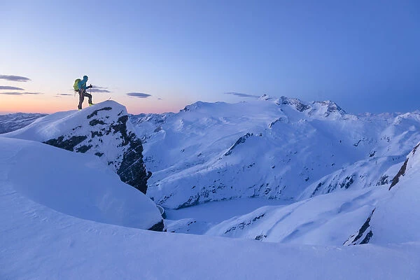 Ski mountaneer near the summit of Lago Peak in Cristallina gruop mountains admiring