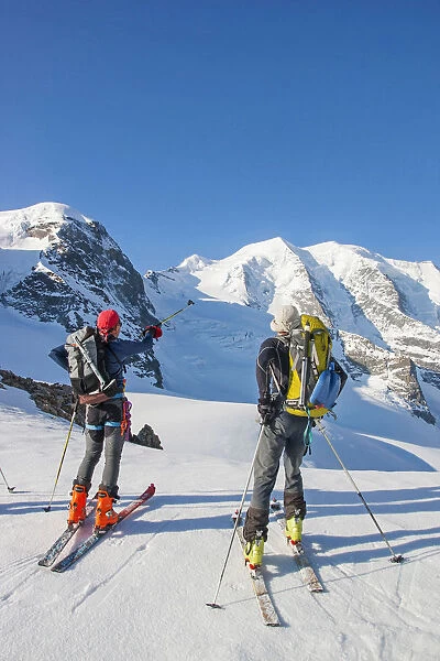 Ski mountaneers in the Bernina glacier looking for piz Palu. Engadina valley, Switzerland