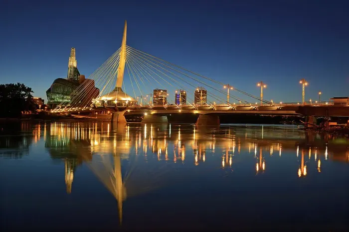 Framed Print : Skyline of the City of Winnipeg reflected in the Red River featuring the Canadian Museum for Human Rights (CMHR) and the Esplanade Riel Bridge at dusk, Winnipeg, Manitoba, Canada Framed Print : Skyline of the City of Winnipeg reflected in the Red River featuring the Canadian Museum for Human Rights (CMHR) and the Esplanade Riel Bridge at dusk, Winnipeg, Manitoba, Canada