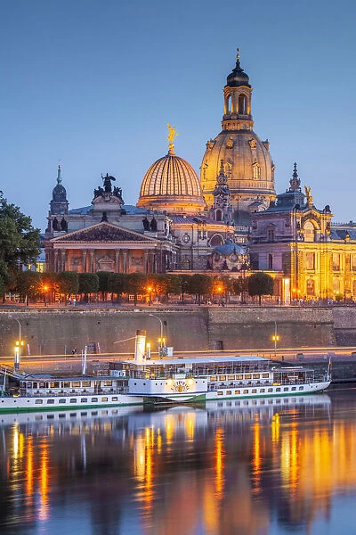 Skyline of Dresden at dusk with Bruehl's Terrace, Academy of Fine Arts, Church of Our Lady, and paddle steamer on river Elbe, Dresden, Saxony, Germany