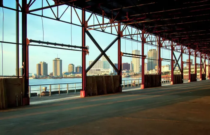Framed Print : The skyline of New Orleans is visible thru the steel frame of an old factory building located in the newly developed Crescent Park on the banks of the Mississippi River in New Orleans. Louisiana, USA